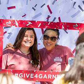 Dawn Staley poses with a fan on Greene Street during 2019 Give 4 Garnet event