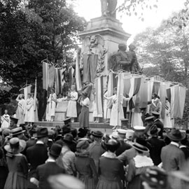 women rally for suffrage at a monument in washington DC in 1918